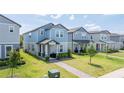 View of multiple modern homes with well-maintained lawns and landscaping in a Gathering-friendly neighborhood at 12133 Bracco St, Winter Garden, FL 34787