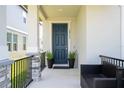 Inviting front porch featuring a dark blue front door, potted plants, and comfortable seating at 12133 Bracco St, Winter Garden, FL 34787