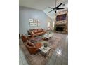 Modern living room with a striking brick fireplace, high ceilings, and comfortable leather furniture for relaxation at 1219 Serissa Ct, Orlando, FL 32818