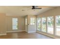 Open-concept living room featuring hardwood floors, plenty of natural light, and neutral paint at 1220 Zapata Pl, Lady Lake, FL 32159