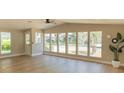 Bright and airy living room with large windows and light wood flooring at 1220 Zapata Pl, Lady Lake, FL 32159