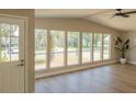 Bright living room featuring multiple windows, a ceiling fan, and wood-look floors at 1220 Zapata Pl, Lady Lake, FL 32159