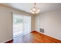 Bright dining area features hardwood floors and a sliding glass door that leads to the backyard at 14 Cyclops Dr, Apopka, FL 32703