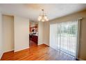 Open dining area with hardwood floors connects to the kitchen, offering a seamless flow and backyard access at 14 Cyclops Dr, Apopka, FL 32703