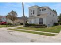 Two-story home featuring beautiful front yard and ample driveway at 166 Minniehaha Cir, Haines City, FL 33844