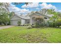 Attractive one-story home with a tidy front lawn, mature landscaping, and an attached garage at 1800 Silver Valley Ct, Apopka, FL 32712
