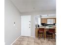 Bright entryway leading to an open kitchen with breakfast bar and tiled flooring at 1803 Foxhall Cir # 1803, Kissimmee, FL 34741