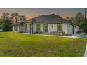 A modern single-story home, complemented by well-manicured lawn, neutral stucco exterior, and an attached garage at 19073 Sabal St, Orlando, FL 32833