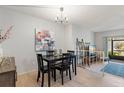 Dining room with modern chandelier and neutral color palette at 200 Maitland Ave # 19, Altamonte Springs, FL 32701