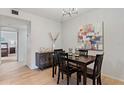 Open dining room featuring a table with seating, decorative lighting, and wood floors at 200 Maitland Ave # 19, Altamonte Springs, FL 32701