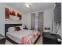 Cozy bedroom featuring a comfortable bed, floral patterned bedding, and soft natural light at 2304 N Hastings St, Orlando, FL 32808