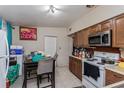 Functional kitchen with essential appliances and adjacent dining area with seating for four at 2304 N Hastings St, Orlando, FL 32808