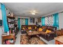 Inviting living room with plush brown sofas, decorative pillows, and a ceiling fan for added comfort at 2304 N Hastings St, Orlando, FL 32808