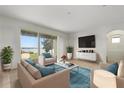Bright living room with expansive windows overlooking the water, complemented by stylish furniture and modern decor at 259 Blue Cypress Dr, Groveland, FL 34736
