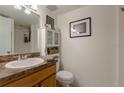 Functional bathroom featuring a vanity, toilet, and built-in storage for toiletries at 2818 Plaza Terrace Dr # 2818, Orlando, FL 32803
