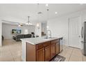 Stylish kitchen island featuring a double sink and a breakfast bar that opens into the living room at 2940 Nottel Dr, St Cloud, FL 34772