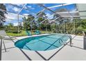 Inviting screened-in pool with blue tile and a spacious deck for lounging at 303 S Sweetwater Blvd, Longwood, FL 32779