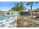 The backyard features a screened-in porch and a pool deck that surrounds the in-ground pool at 3054 Bluebrook Dr, Winter Park, FL 32792