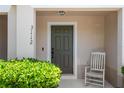 Close-up of front porch, showing a lovely chair and well-kept landscaping at 3112 Seaview Castle Dr, Kissimmee, FL 34746