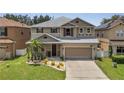 Charming two-story home with a well-manicured lawn, complemented by a two-car garage and neutral color scheme at 325 Aldridge Ln, Davenport, FL 33897