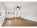 Bright, open-concept living room with tile floors and view of the kitchen at 3591 Sandlor Dr, Deltona, FL 32738