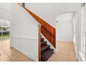 Traditional stairway with wood railing and accents leading to the upper level at 3591 Sandlor Dr, Deltona, FL 32738