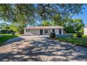 Single-story home with a stone accent wall and well-manicured front yard at 4226 Kelly Miller Ct, Orlando, FL 32811