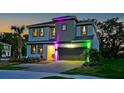 A stunning two-story home is enhanced with custom lighting, a lush yard, and a convenient two-car garage at 4441 Ganesha Loop, Kissimmee, FL 34746