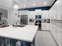 Bright kitchen with white cabinets, stainless steel appliances, and quartz countertops at 454 Captiva Dr, Davenport, FL 33896
