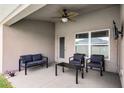 Cozy covered patio with comfortable seating, perfect for outdoor relaxation and entertaining at 503 Meadow Pointe Dr, Haines City, FL 33844