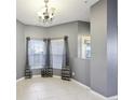Dining room with neutral gray walls, two large windows and ceramic tile floors at 585 Cruz Bay Cir, Winter Springs, FL 32708
