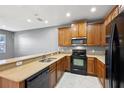 Kitchen with wood cabinets, stainless steel appliances, and gray walls at 585 Cruz Bay Cir, Winter Springs, FL 32708