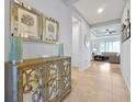 Inviting foyer featuring elegant decor, tiled flooring, and a view into the living room at 634 Via Corso Ct, Kissimmee, FL 34759