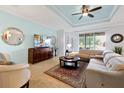 Comfortable living room with tile floors, stylish furniture, and a ceiling fan for added comfort at 634 Via Corso Ct, Kissimmee, FL 34759