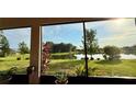 Relaxing screened patio view of the landscaped lawn and serene lake waters at 634 Via Corso Ct, Kissimmee, FL 34759
