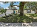 Charming single-story home with an eye catching front door, attractive landscaping, and mature trees at 641 Peachwood Dr, Altamonte Springs, FL 32714