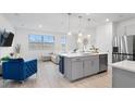 Modern open-concept kitchen with stainless steel appliances and a kitchen island at 733 Longboat Dr, Davenport, FL 33896