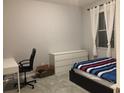 Bright bedroom with a comfy bed, white dresser, desk and a chair, perfect for relaxation at 15708 Orange Harvest Loop, Winter Garden, FL 34787