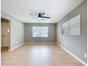 Bright living room featuring light wood floors, neutral walls, and contemporary ceiling fan at 116 7Th St, Winter Haven, FL 33880