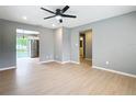 Light-filled living room with views into kitchen and bathroom and light wood flooring at 116 7Th St, Winter Haven, FL 33880