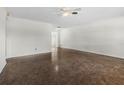 Bright living room featuring a ceiling fan, neutral walls, and polished terrazzo floors at 1340 Continental Dr, Daytona Beach, FL 32117