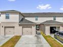 Townhome exteriors show garage access via driveways, and a courtyard style area behind the center unit at 1555 Dawnview Way, Kissimmee, FL 34744