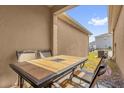 Relaxing outdoor dining space featuring a stone-top table and seating on a screened patio at 1555 Dawnview Way, Kissimmee, FL 34744