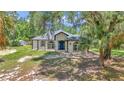 Well-maintained single story home featuring arched windows, covered entry, and a verdant front lawn at 16758 Ne 135Th Ave, Fort Mc Coy, FL 32134