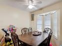 Dining area with a dark wood table, ornate chairs, and natural light from the window at 1806 Foxhall Cir # 1806, Kissimmee, FL 34741