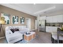Inviting living room seamlessly connects to the kitchen with stainless steel appliances and modern cabinetry at 2117 Greenwood Oak Dr, Ocoee, FL 34761