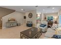 Open-concept living room with tile flooring, a comfortable seating area, and seamless flow to the kitchen and dining spaces at 2238 Hawick Ln # 2238, Winter Park, FL 32792