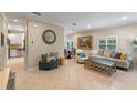Bright living room with tile floors, a comfortable sofa, and views into the kitchen and dining areas, perfect for entertaining at 2238 Hawick Ln # 2238, Winter Park, FL 32792