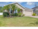 Inviting single-story home with well-manicured lawn and mature palm trees at 2426 Addison Creek Dr, Kissimmee, FL 34758