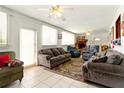 Bright living room featuring neutral paint, tile floors, and a comfortable seating area at 2504 Caribbean Ct, Orlando, FL 32805